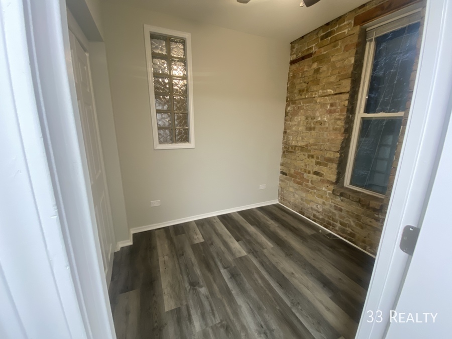 1246 North Cleaver Street, Unit 1R Chicago, IL 60642 - Photo 5 of 8 a view of wooden floor