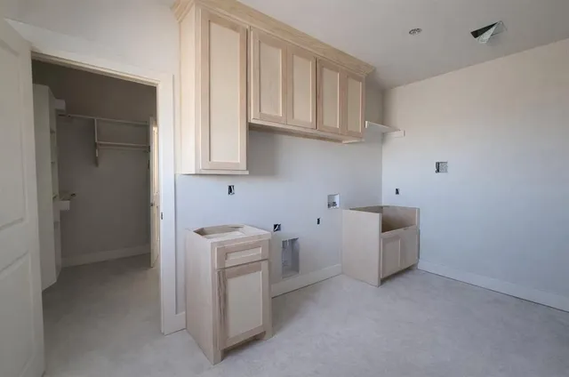 a room with cabinets and washer