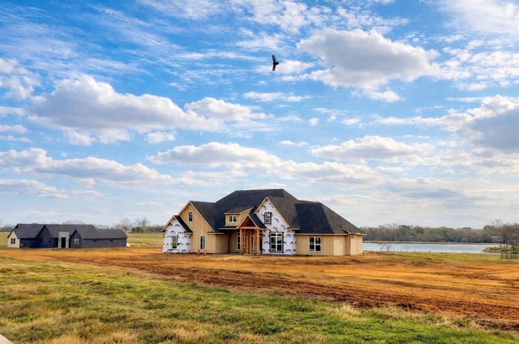 176 Vaughn Lane Calera, OK 74730 - Photo 2 of 21 a view of a large house with a big yard and large trees