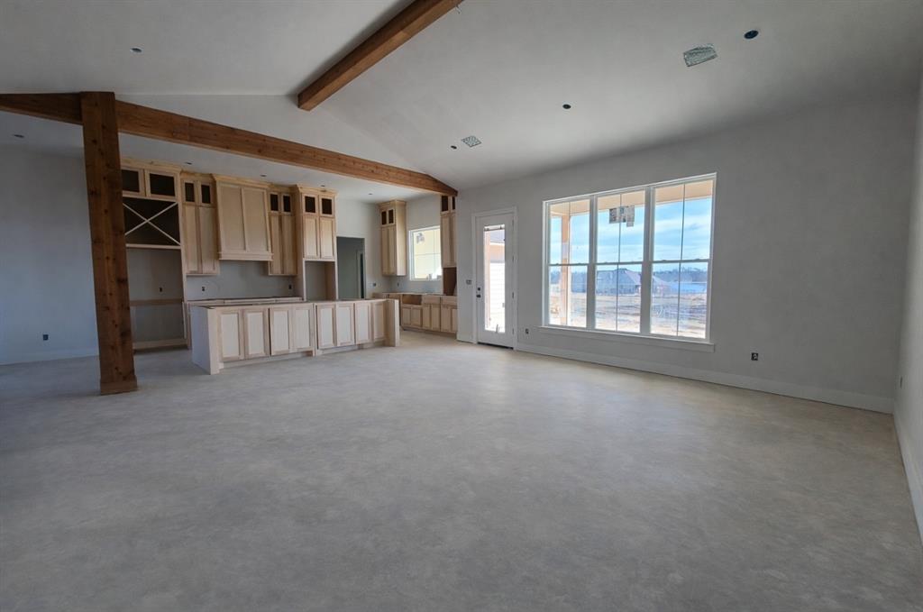 176 Vaughn Lane Calera, OK 74730 - Photo 5 of 21 an empty room with fireplace and windows