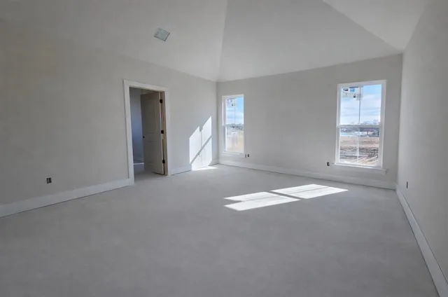 an empty room with windows and closet
