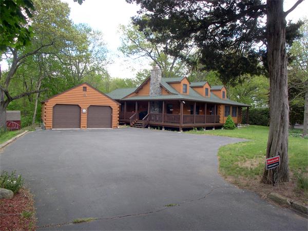 64 Bethany Road Framingham, MA 01702 - Photo 2 of 30 a front view of a house with a yard and garage
