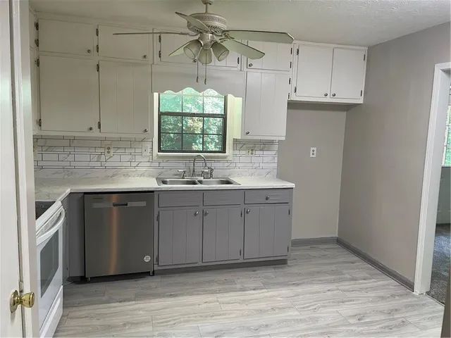 a kitchen with a sink cabinets and window