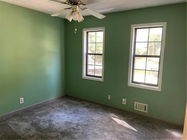 a room with a window and ceiling fan
