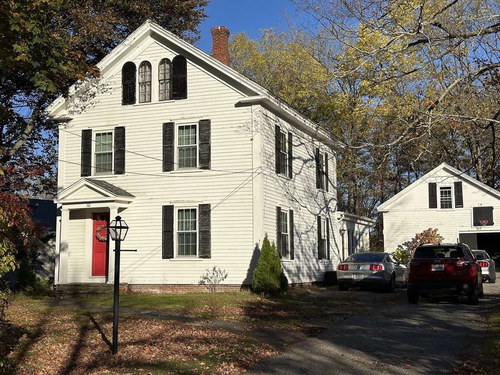 10 Maple Street Sturbridge, MA 01566 - Photo 1 of 30 a view of a white house with large windows next to a road