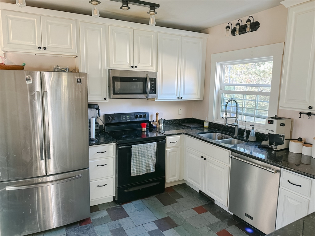 10 Maple Street Sturbridge, MA 01566 - Photo 16 of 30 a kitchen with granite countertop a refrigerator sink and microwave