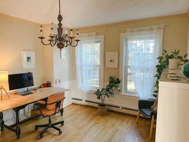 a view of a dining room with furniture window and wooden floor