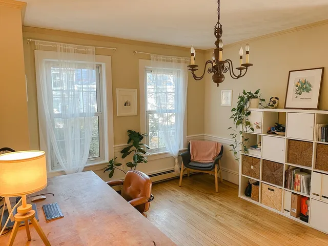 a living room with furniture a rug and a chandelier