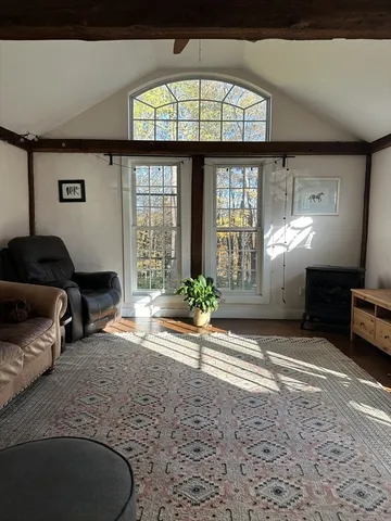 a view of a livingroom with furniture and staircase