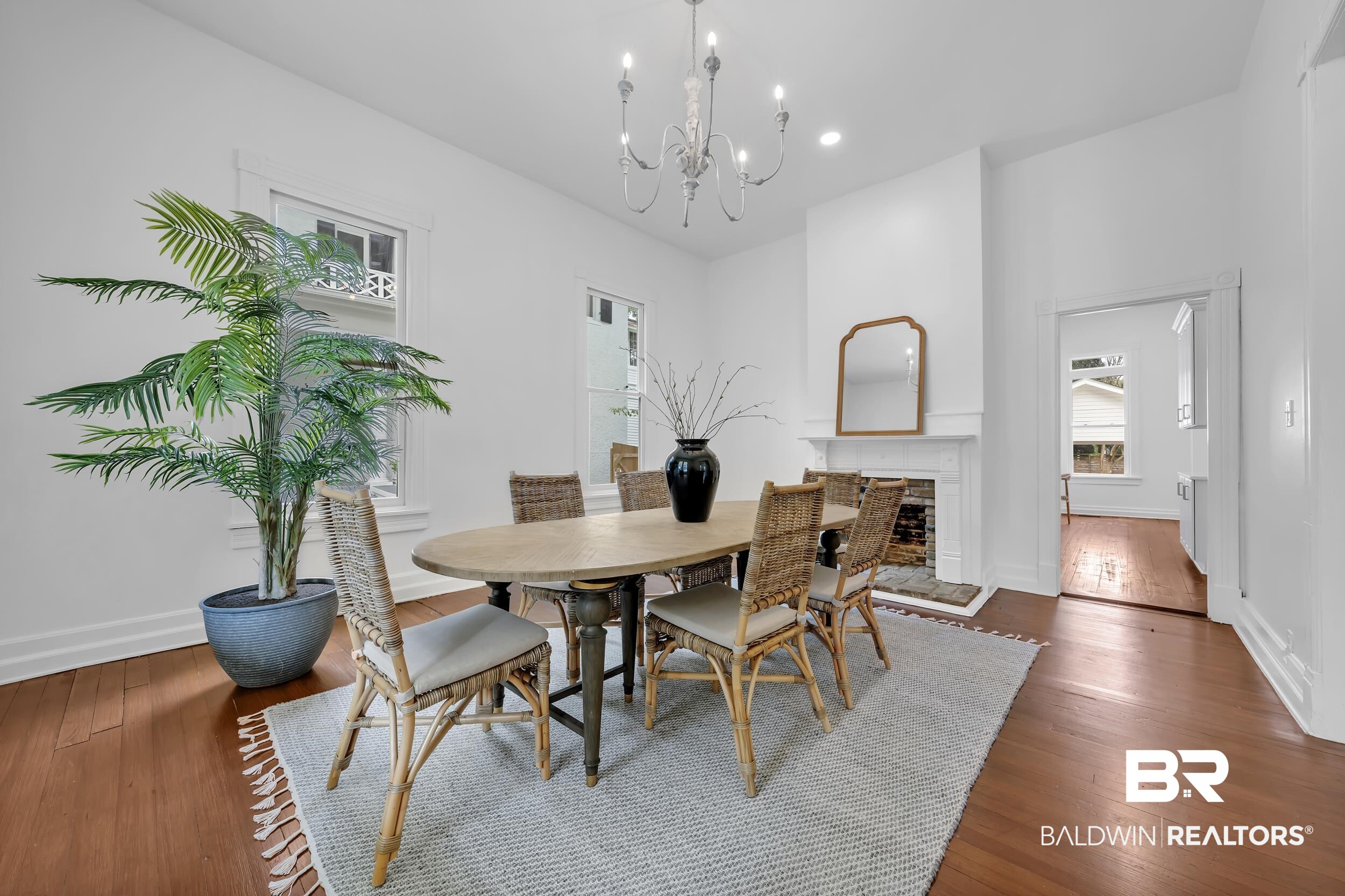 1662 Government Street Mobile, AL 36604 - Photo 14 of 33 Dining room with dark wood finished floors, a chandelier, a stone fireplace, and recessed lighting