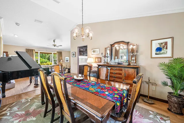 a kitchen with stainless steel appliances kitchen island granite countertop a refrigerator stove top oven and sink