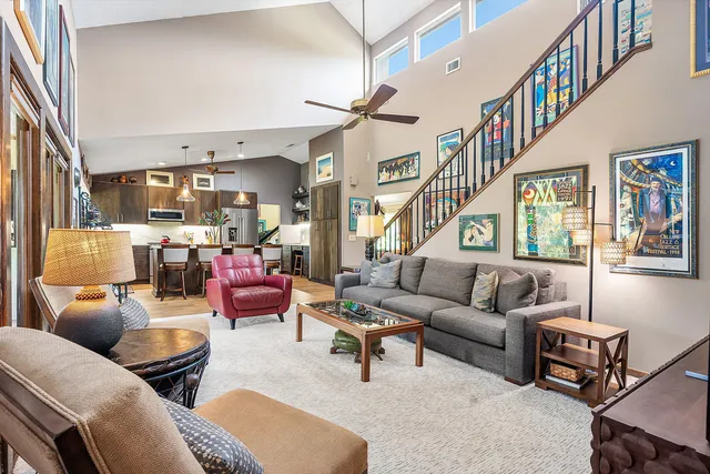 a living room with furniture a flat screen tv and a window