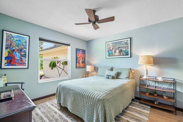 an aerial view of residential houses with outdoor space and trees all around