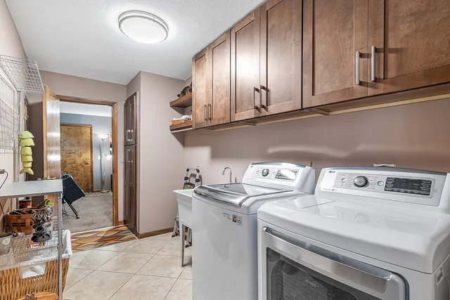 an aerial view of a house with a garden and trees