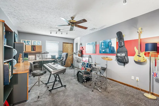 an aerial view of a swimming pool with a yard and outdoor seating