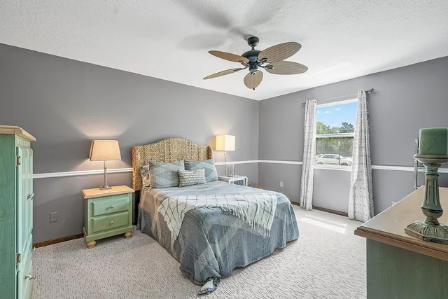 an aerial view of a swimming pool with a yard and outdoor seating