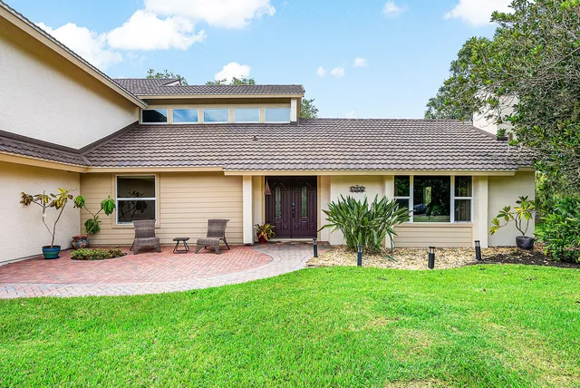 a living room with furniture a fireplace and a window