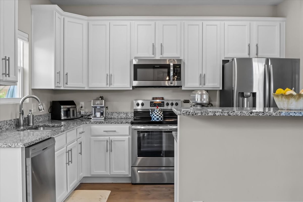 10011 Wendy Way Lyles, TN 37098 - Photo 11 of 51 a kitchen with stainless steel appliances granite countertop a stove a sink and white cabinets