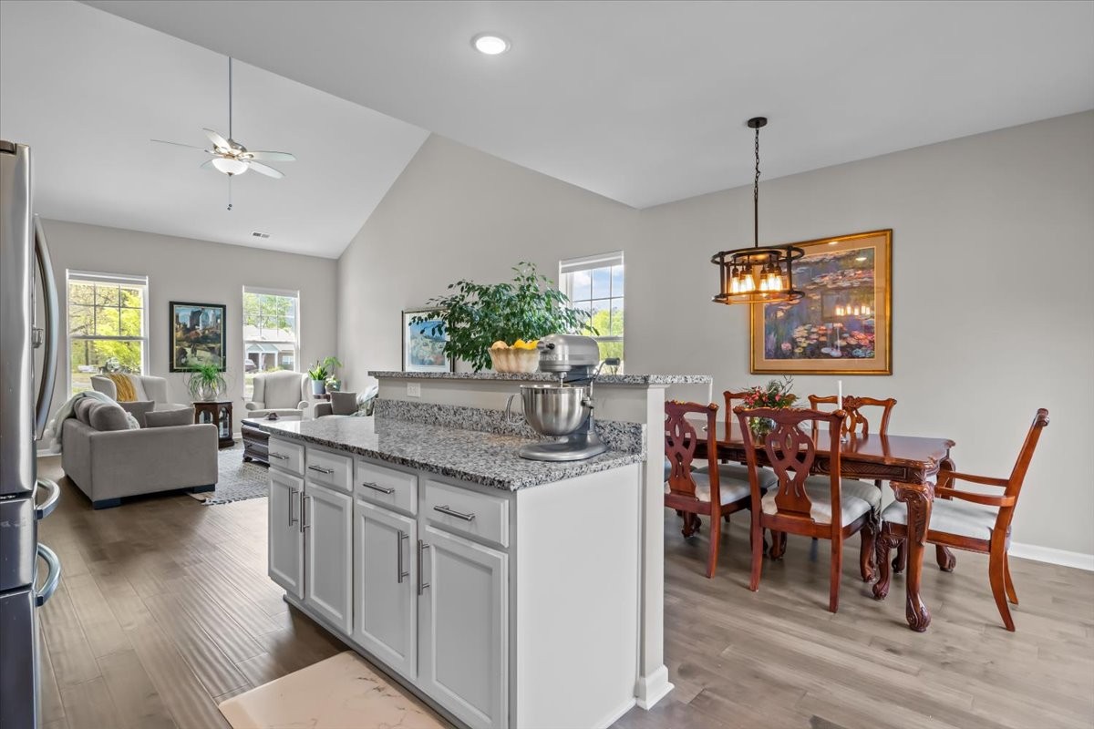 10011 Wendy Way Lyles, TN 37098 - Photo 12 of 51 a kitchen with stainless steel appliances granite countertop wooden floor dining table and chairs