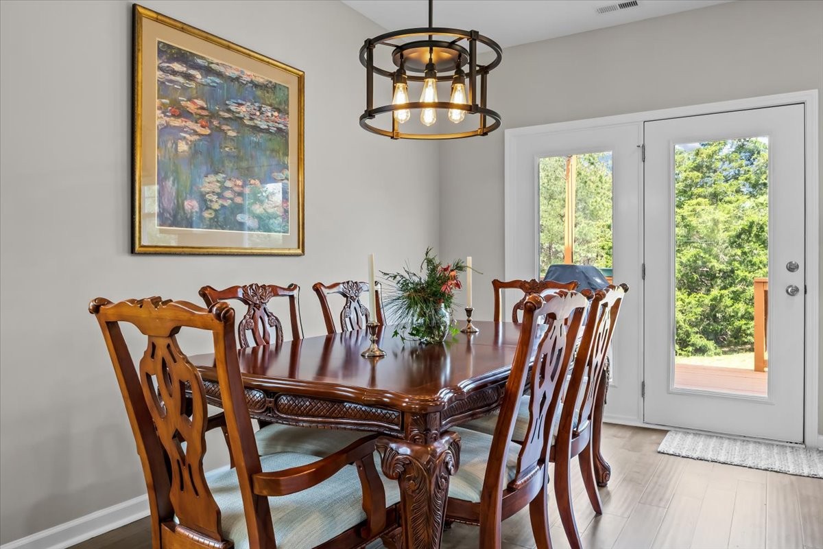 10011 Wendy Way Lyles, TN 37098 - Photo 13 of 51 a view of a dining room with furniture a chandelier and wooden floor