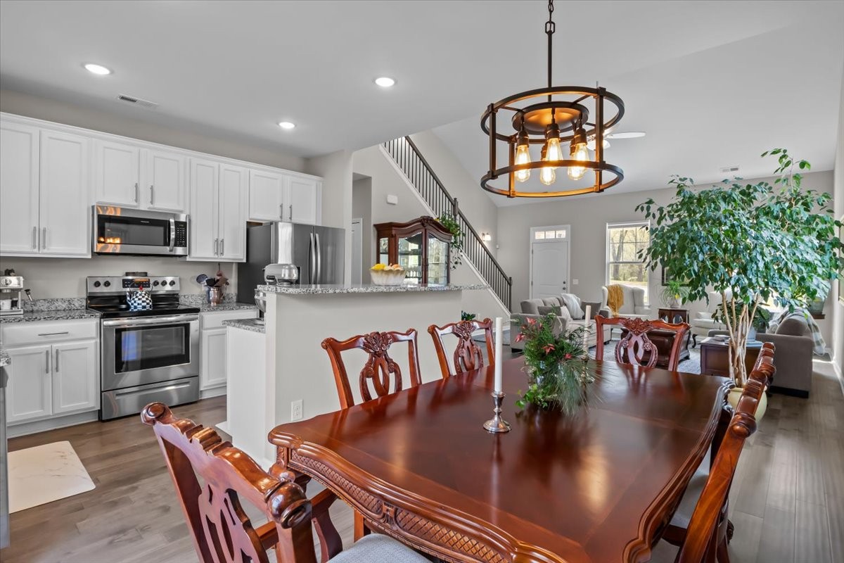 10011 Wendy Way Lyles, TN 37098 - Photo 14 of 51 a kitchen with stainless steel appliances granite countertop a dining table chairs stove and white cabinets