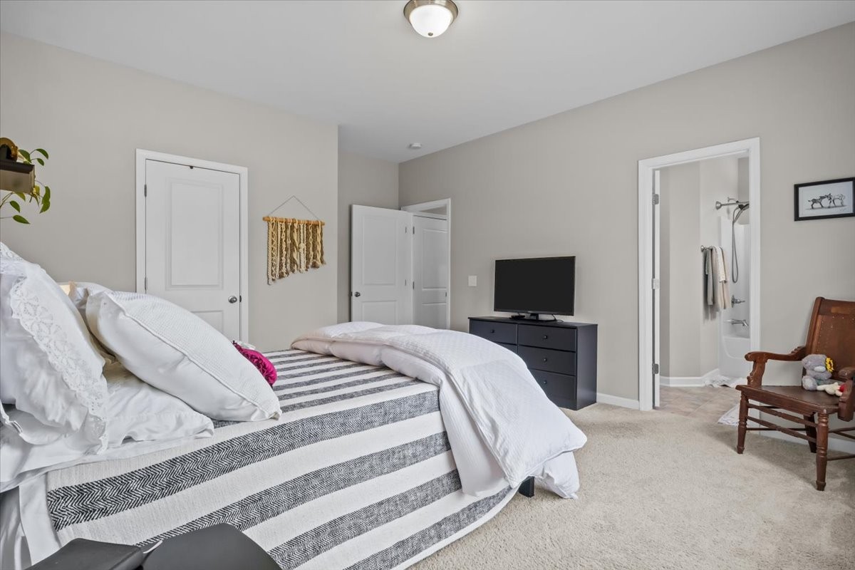 10011 Wendy Way Lyles, TN 37098 - Photo 19 of 51 a bedroom with a bed and a flat screen tv