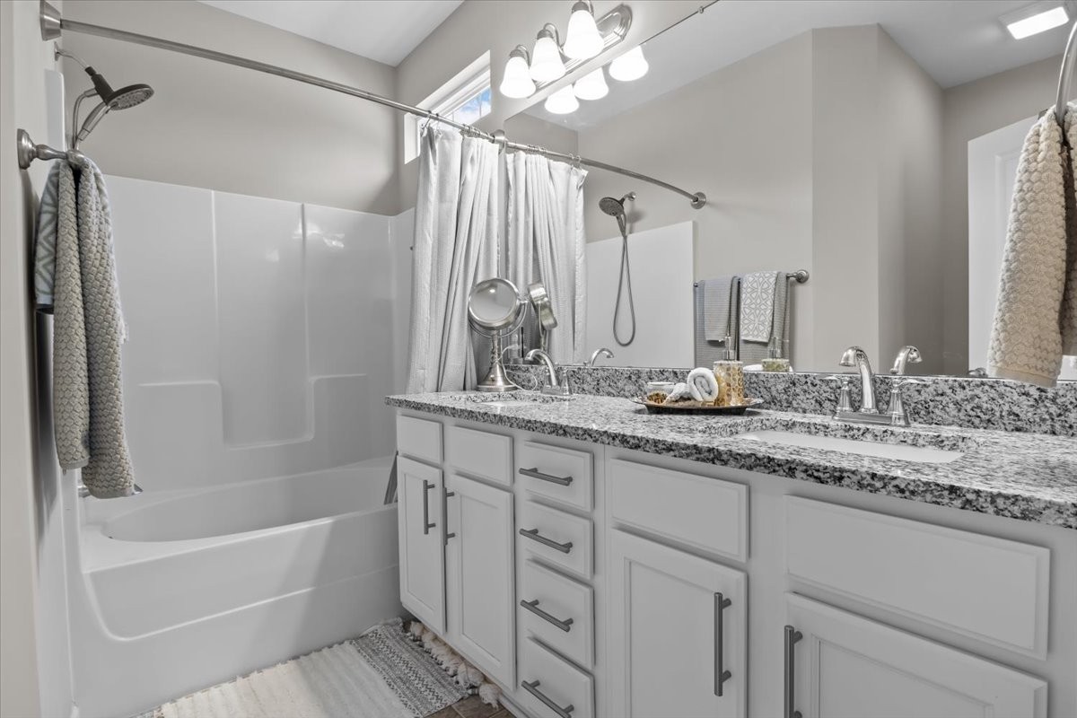 10011 Wendy Way Lyles, TN 37098 - Photo 24 of 51 a bathroom with a granite countertop sink a mirror a shower and a bathtub