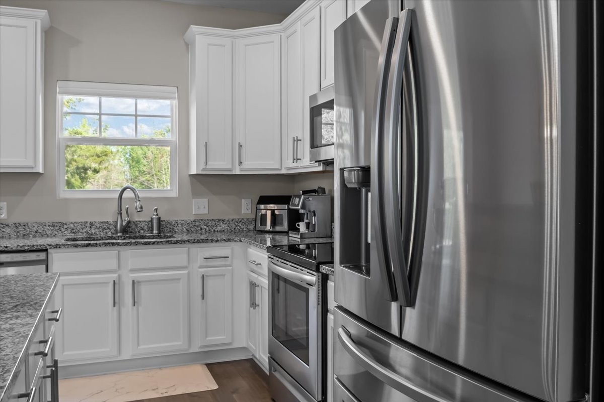 10011 Wendy Way Lyles, TN 37098 - Photo 9 of 51 a kitchen with stainless steel appliances granite countertop a refrigerator sink and cabinets