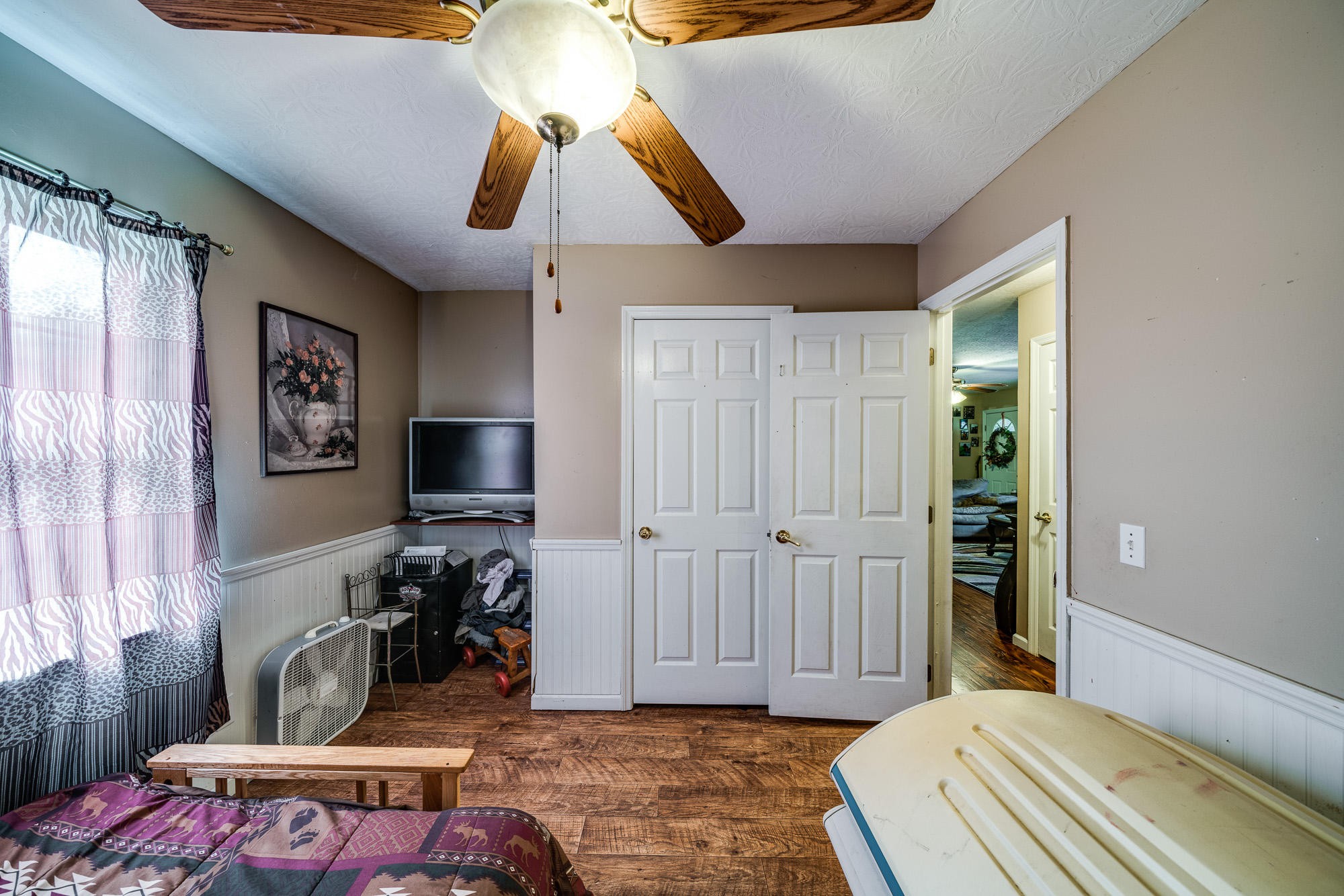 1556 Bicknell Road Clarkrange, TN 38553 - Photo 14 of 40 a bedroom with a bed and a chandelier