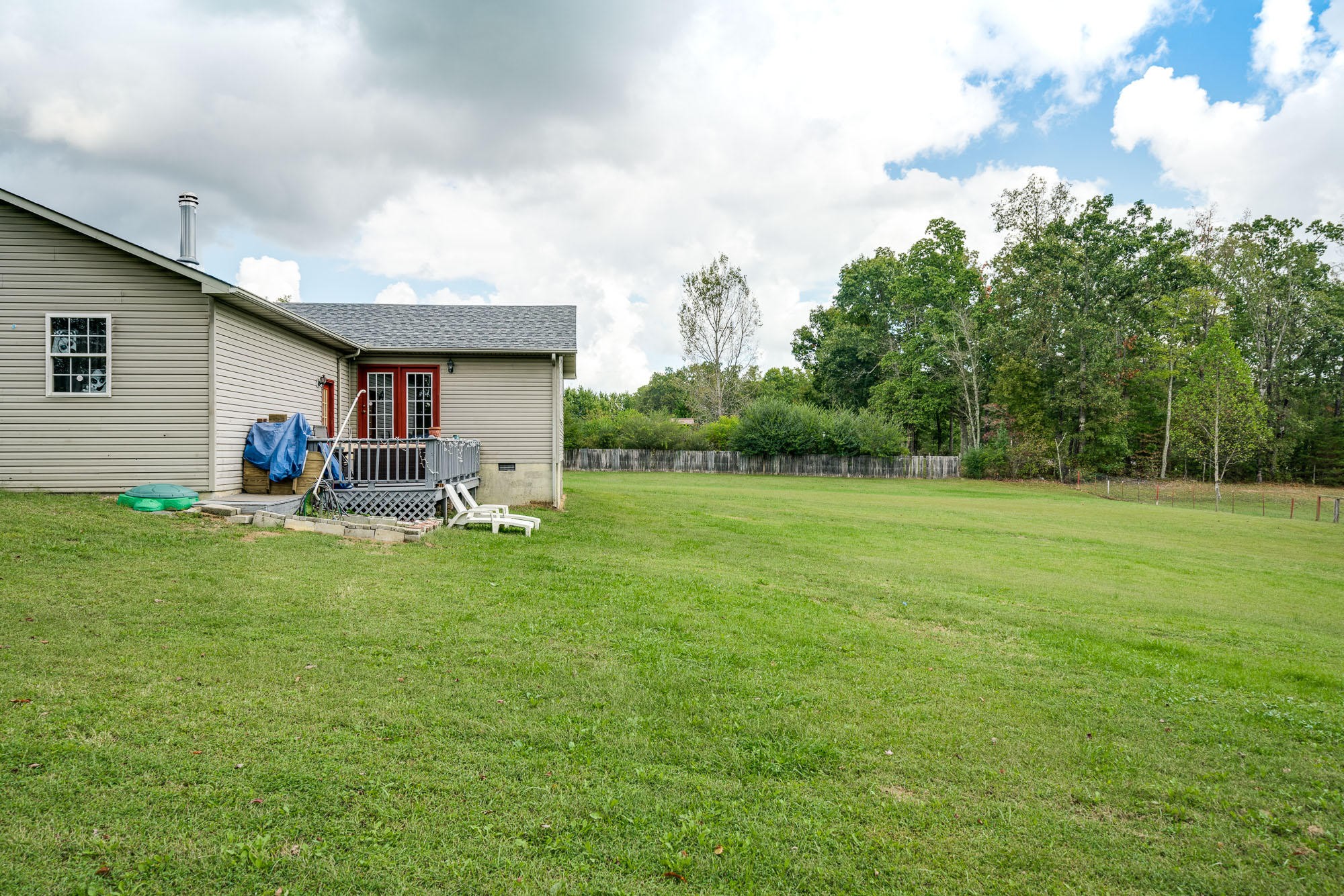 1556 Bicknell Road Clarkrange, TN 38553 - Photo 31 of 40 a backyard of a house with table and chairs