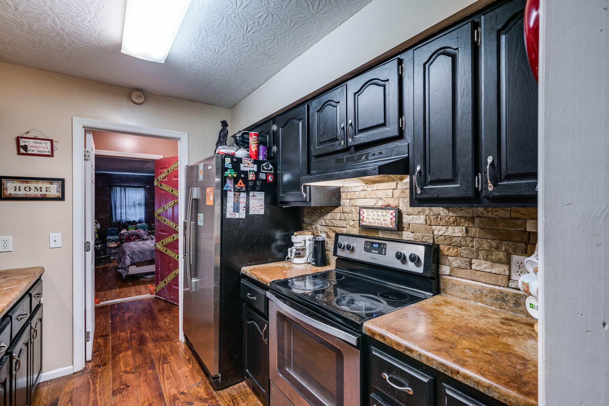 1556 Bicknell Road Clarkrange, TN 38553 - Photo 35 of 40 a kitchen with wooden cabinets and a stove top oven