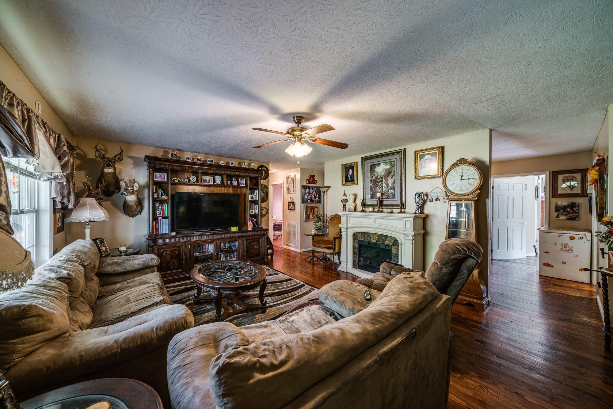 1556 Bicknell Road Clarkrange, TN 38553 - Photo 39 of 40 a living room with furniture a fireplace and a flat screen tv