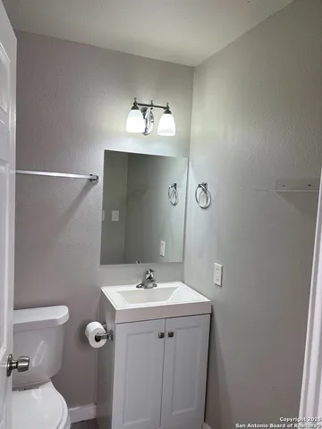 a bathroom with a sink toilet and mirror