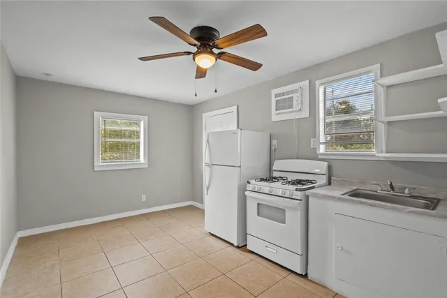 a kitchen with a stove cabinets and window