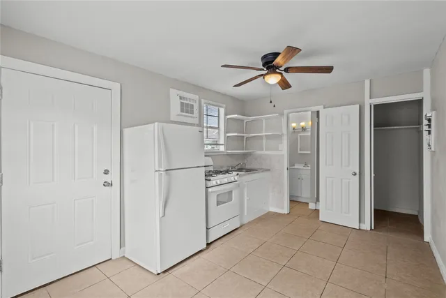 a kitchen with white cabinets and white appliances