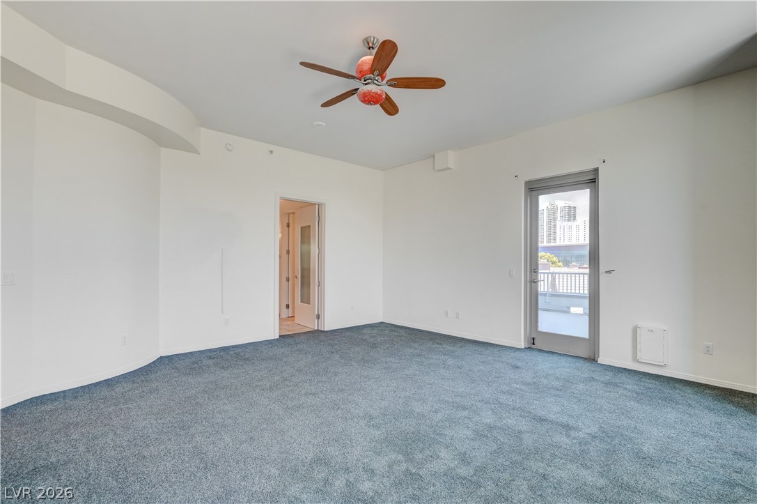 360 East Desert Inn Road, Unit 402 Las Vegas, NV 89109 - Photo 17 of 40 A spacious, naturally illuminated room featuring plush carpeting and a private balcony.