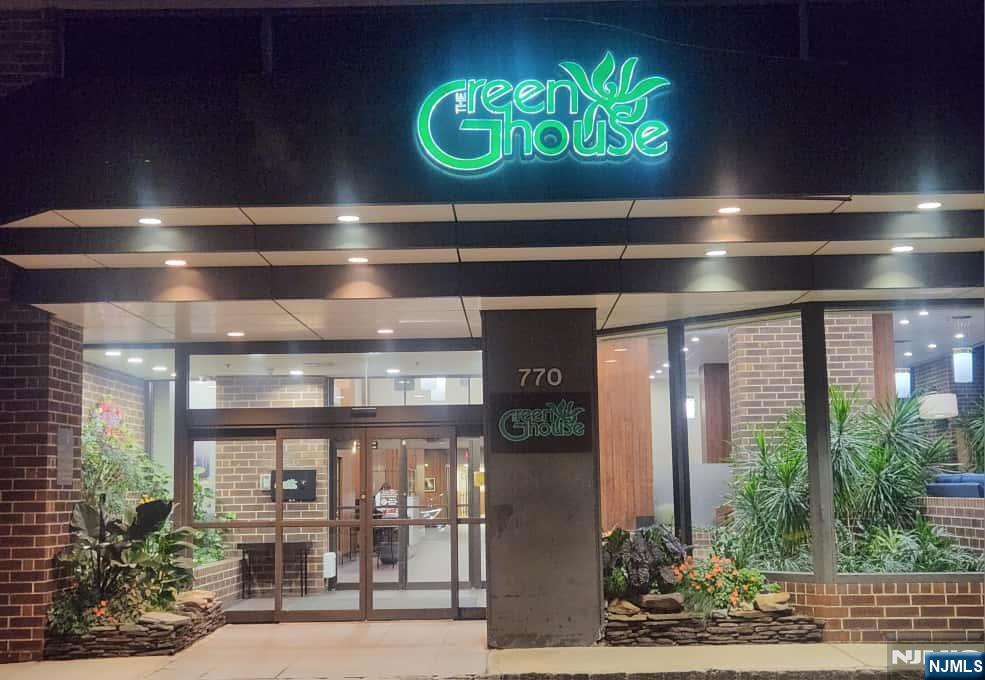 a view of a entryway door with potted plants