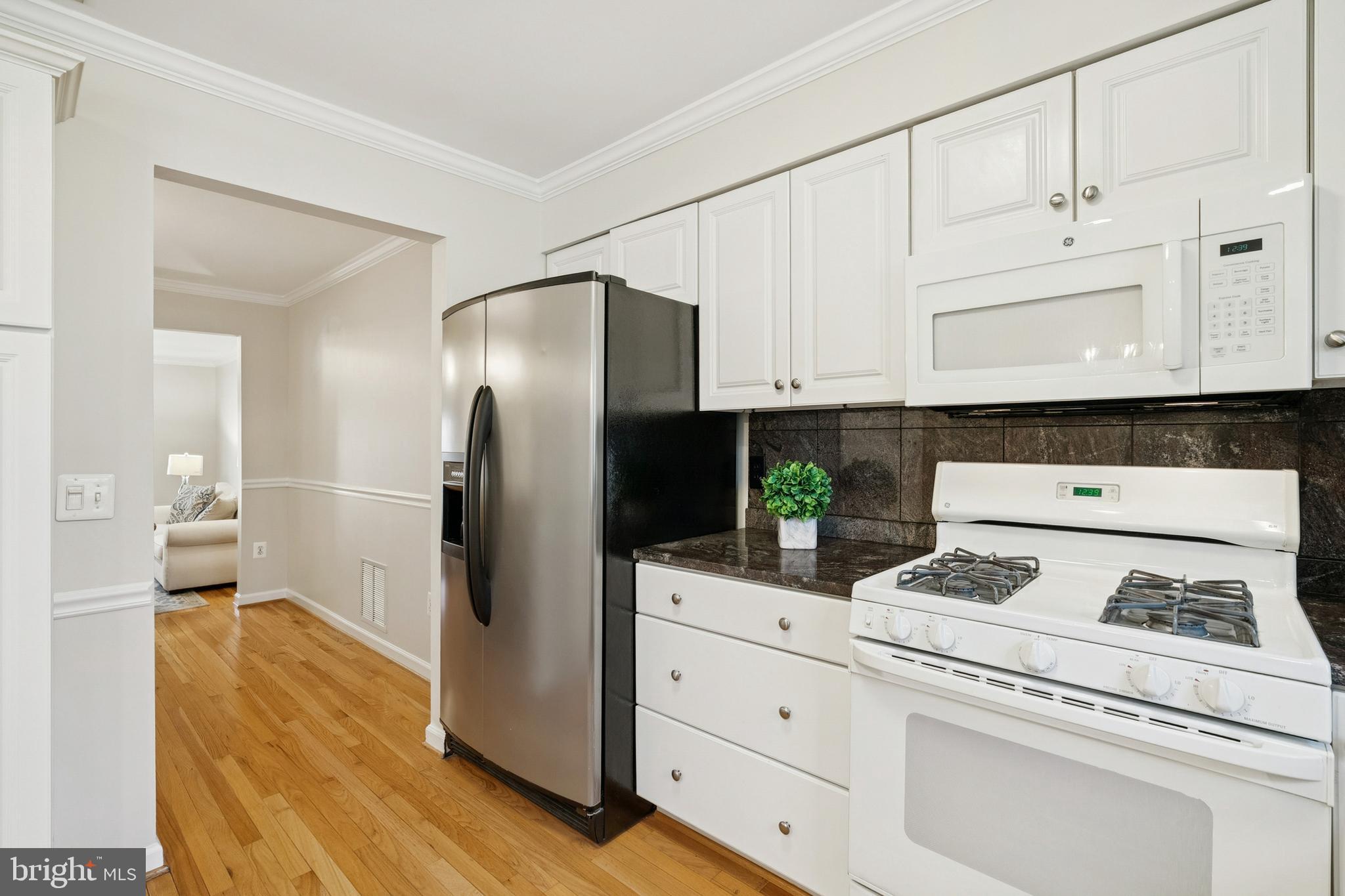 7810 Ashley Glen Road Annandale, VA 22003 - Photo 10 of 33 a kitchen with granite countertop white cabinets and stainless steel appliances