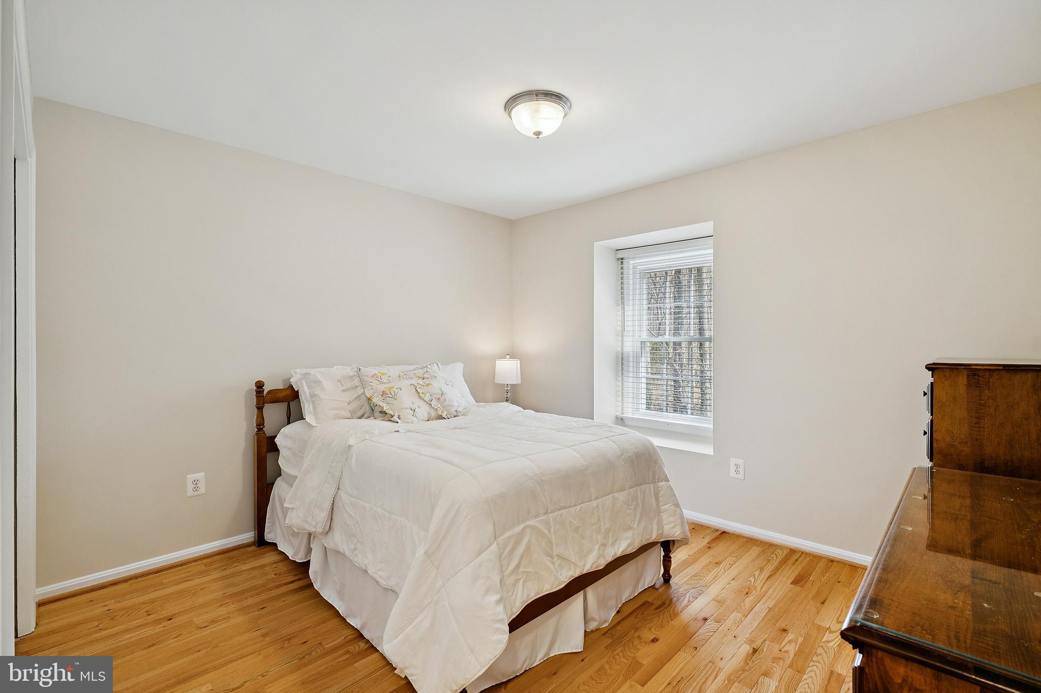 7810 Ashley Glen Road Annandale, VA 22003 - Photo 18 of 33 a bedroom with a bed and wooden floor