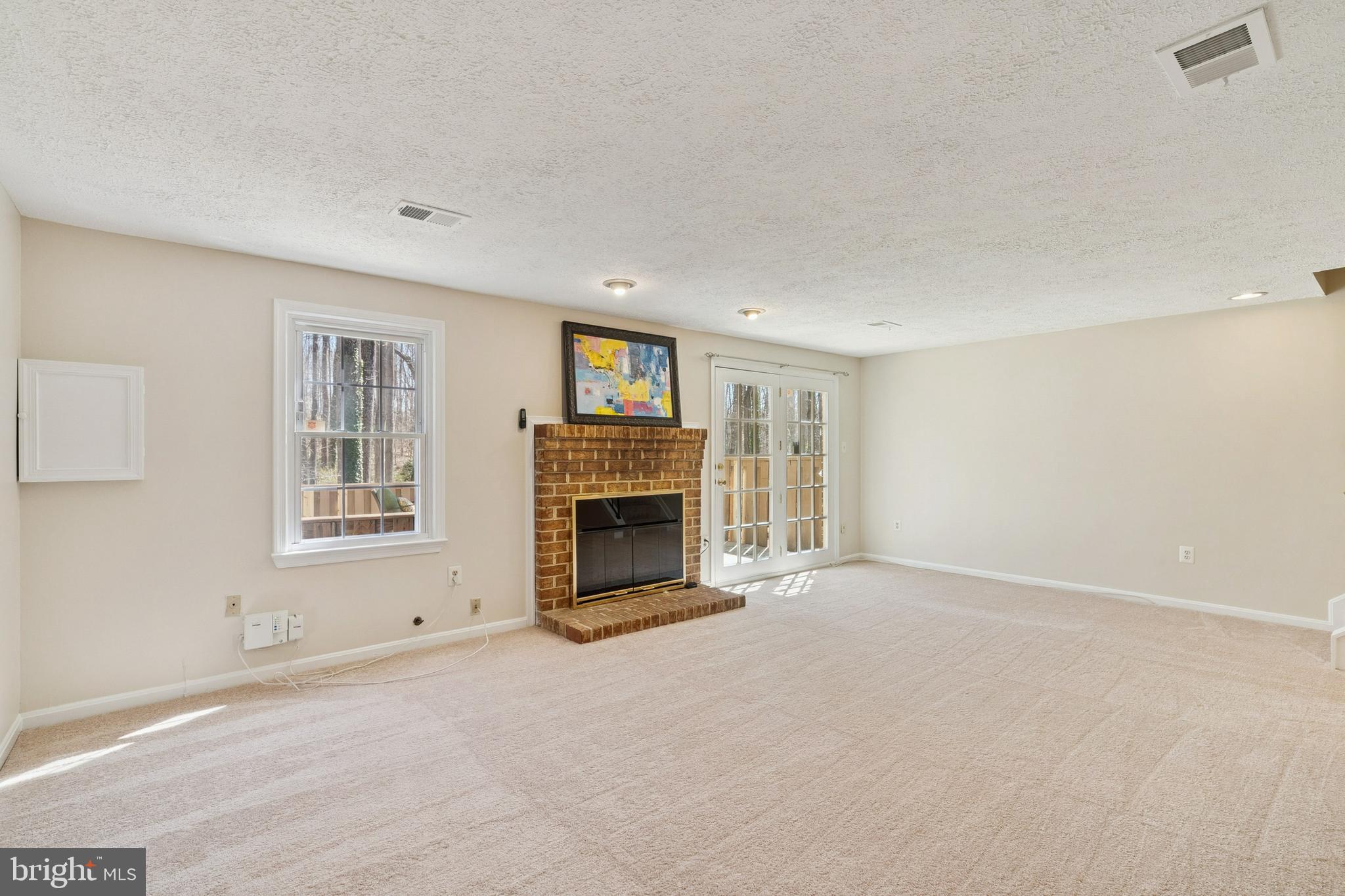 7810 Ashley Glen Road Annandale, VA 22003 - Photo 23 of 33 a view of an empty room with a fireplace and a window