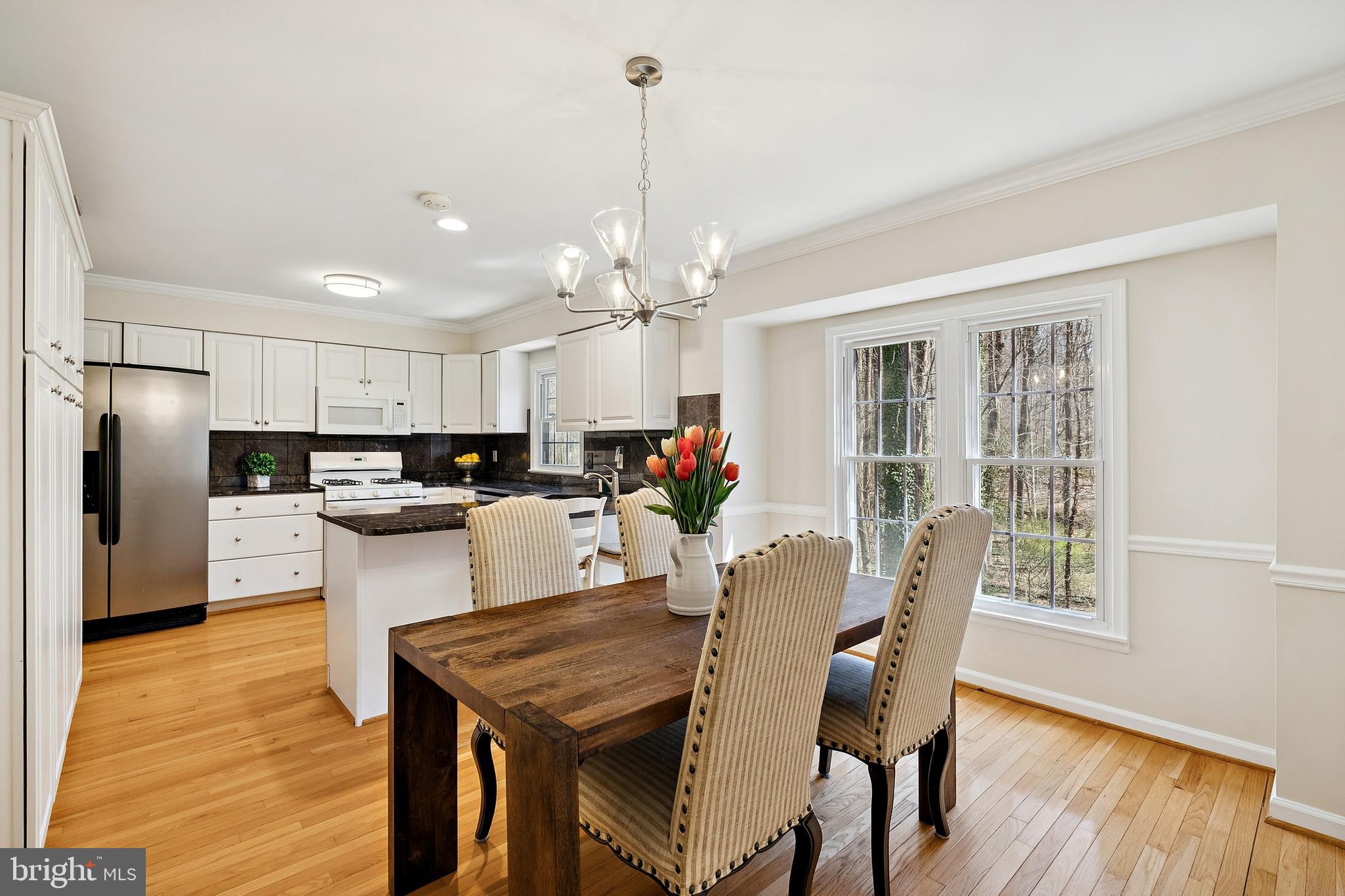7810 Ashley Glen Road Annandale, VA 22003 - Photo 7 of 33 a view of kitchen with refrigerator dining table and chairs