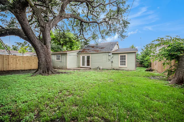 a view of a house with a tree in a yard