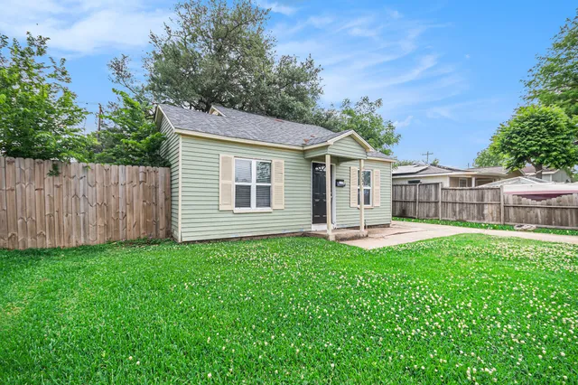 a view of a house with a yard and sitting area