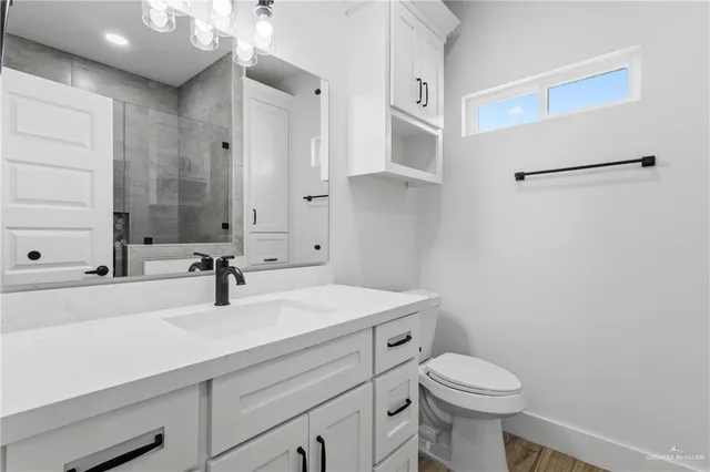 a bathroom with a sink a toilet and mirror