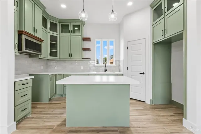 a kitchen with stainless steel appliances granite countertop a sink and a stove top oven