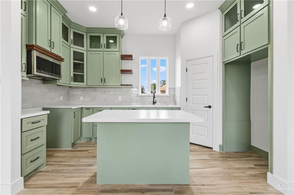 1921 Trinity Street Donna, TX 78537 - Photo 5 of 18 a kitchen with stainless steel appliances granite countertop a sink and a stove top oven