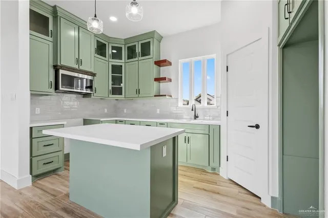 a kitchen with a sink and a refrigerator