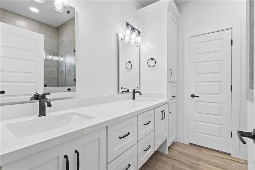 1921 Trinity Street Donna, TX 78537 - Photo 9 of 18 a bathroom with double vanity sinks and a mirror