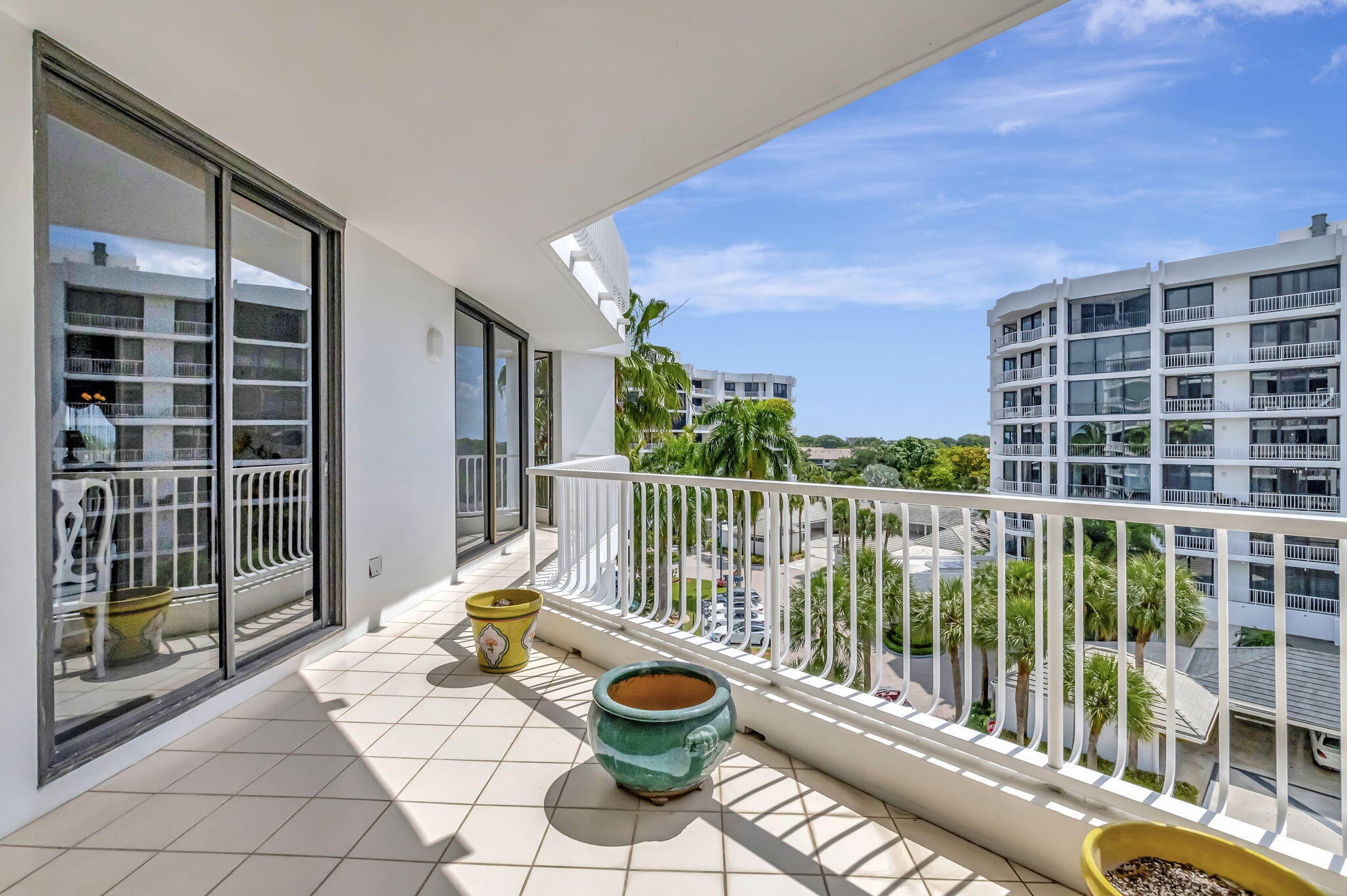 20290 Fairway Oaks Drive, Unit 254 Boca Raton, FL 33434 - Photo 57 of 104 a view of a balcony with floor to ceiling window and wooden fence