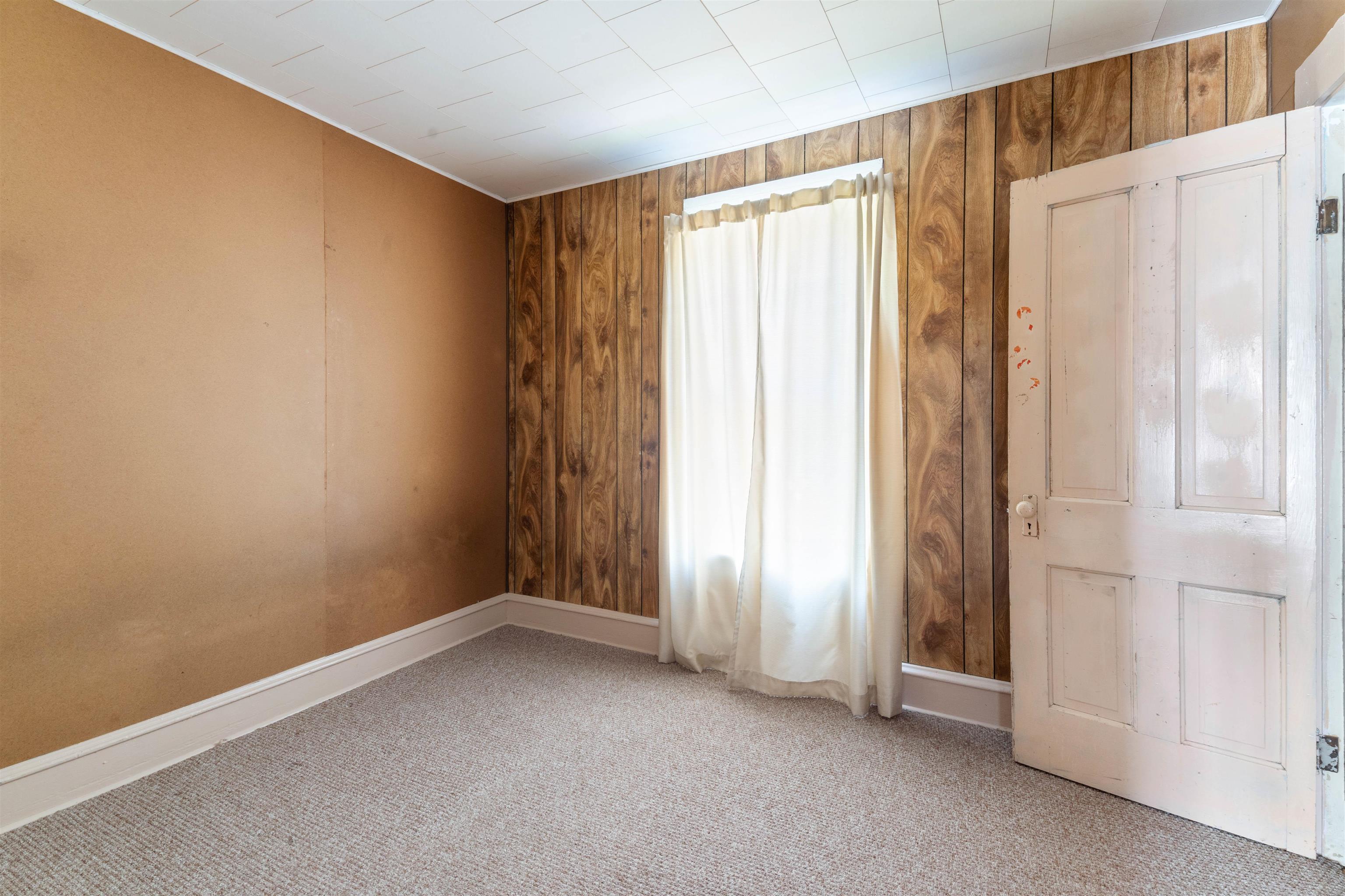 1301 North 11th Street Superior, WI 54880 - Photo 11 of 21 Spare room with wooden walls and carpet